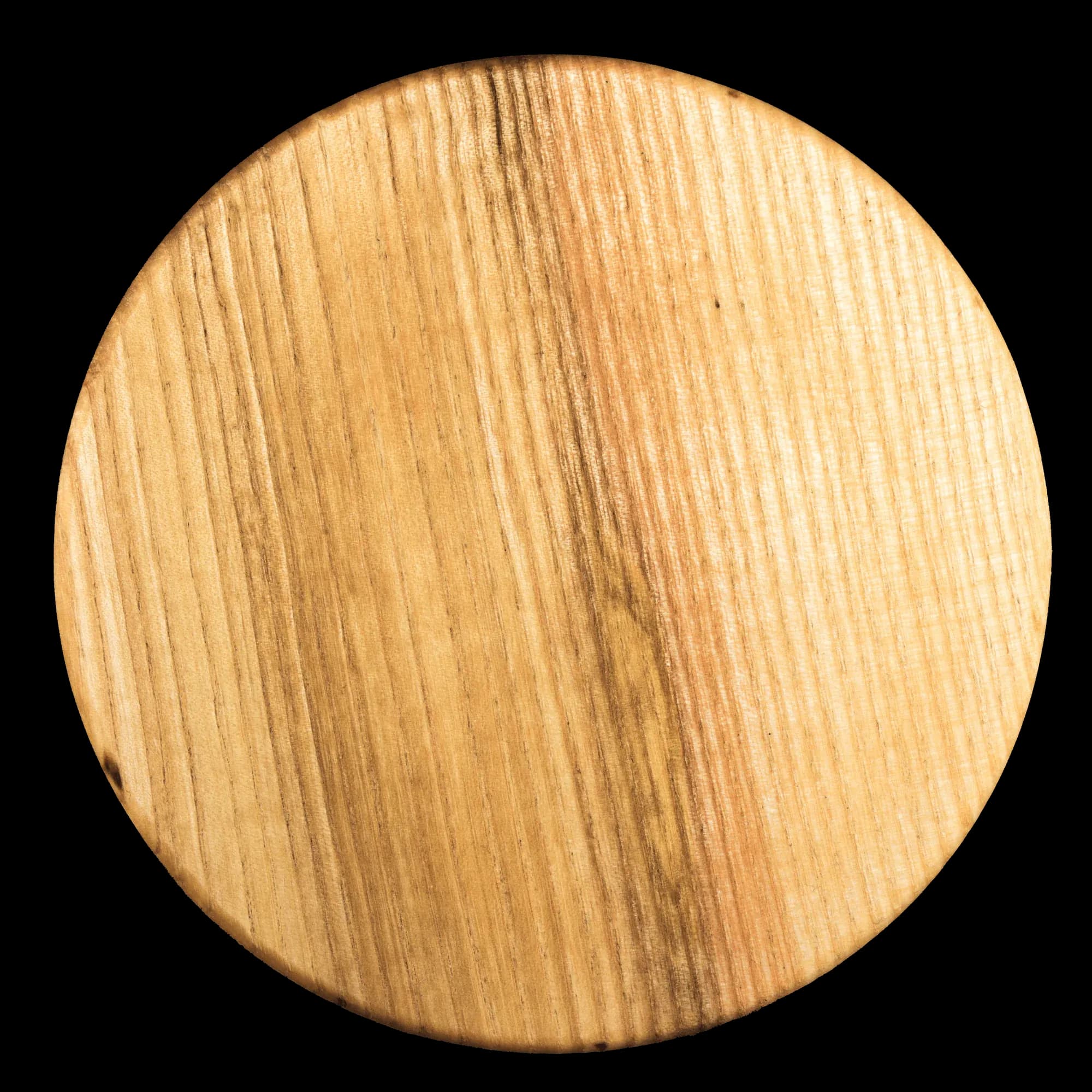 Round ash wood coaster, oiled and waxed, showing the grain and thickness